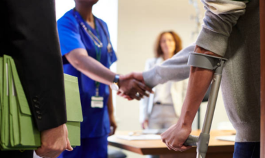 A man with crutches and a woman with a clipboard, representing medical injury law